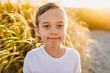 © Kelsey Smith/Stocksy - Young boy in front of beachgrass at sunset