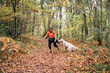 © Daniel Gonzalez/Stocksy - A beautiful woman has fun with her dog in autumn