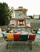 Lighted Outdoor Fireplace On Fall Day