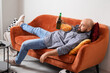 Funny lazy man drinking beer and eating chips while watching TV at home