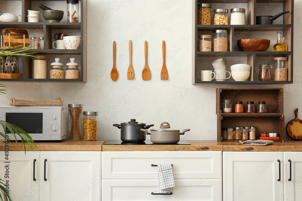 Interior of light modern kitchen with white counters and shelves Stock ...