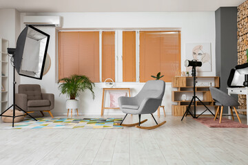 Poster - Interior of modern photo studio with lighting equipment and furniture