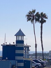 Wall Mural - Blue and white wooden lighthouse on the sea