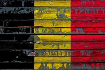 Wall Mural - The national flag of Belgium. is painted on uneven boards. Country symbol.