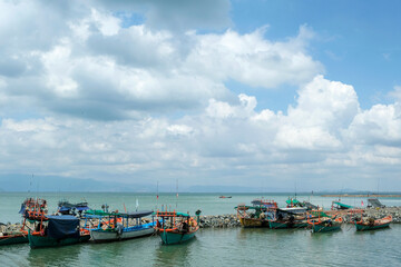 Wall Mural - Kep, Cambodia - February 2022: Fishing boats on Kep beach on February 15, 2022 in Kep, Cambodia.