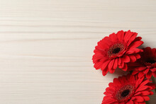 Bouquet Of Beautiful Red Gerbera Flowers On Wooden Background, Top View. Space For Text