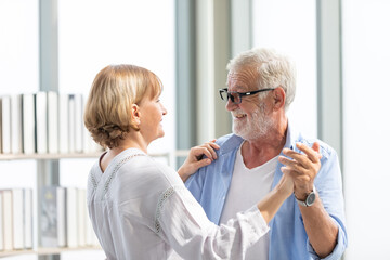 Wall Mural - senior couple, elderly man and woman dancing together in free time