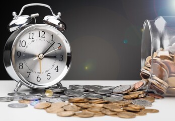 Poster - money background, coins and alarm clock on the table, concept of bank deposits,