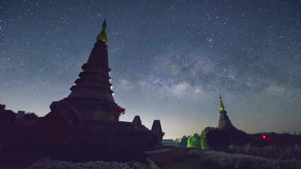 Wall Mural - time lapse 4k of the milky way galaxy moving over a sacred temple at doi inthanon national park, chi