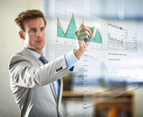 Poster - Digital corporate analysis. Cropped shot of a handsome young businessman plotting graphs using a digital interface.