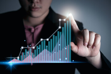 businessman touches financial charts and stock market digital charts on a virtual display screen. Concept of visualization of growing report data with virtual curves.