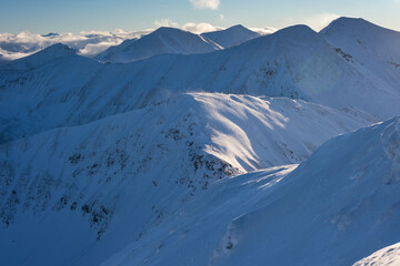 Wall Mural - beautiful winter views of the high tatra mountains with tourists, skiers and amazing states of natur