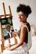© (JLco) Julia Amaral - Cheerful young woman painting in her art studio