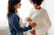 © (JLco) Julia Amaral - Happy woman touching a surrogate mother's belly bump