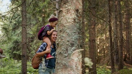 Wall Mural - family with small children walking outdoors in summer nature.