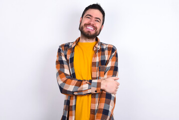 Sticker - young caucasian man wearing plaid shirt over white background laughing.