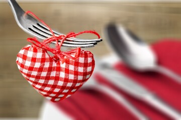 Wall Mural - Heart on a fork. Festive table setting. The concept of a holiday for cafes and restaurants.