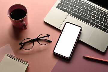 Poster - Top view sweet color flat lays of a cup of coffee, note book, pencil, smartphone ,glasses and laptop on a pink background , for business and technology concept.