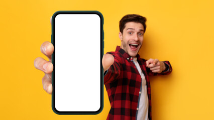 Poster - Excited guy pointing at white empty smart phone screen