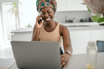 black african traditional woman working from home wearing headscarf