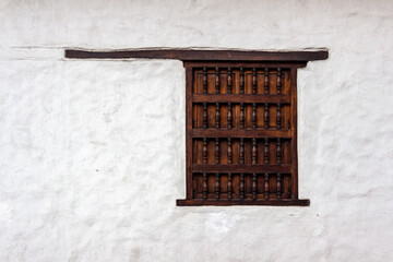 Canvas Print - minimalist white traditional colonial facade with a wooden carved window, cali, valle del cauca, col