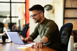 © JustLife - Young businessman using laptop in his office. Handsome man working on the project