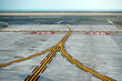Curving yellow lines on the airport asphalt, with guidelines for taxiing aircraft.