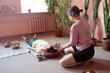 a young woman conducts a session to a client with Tibetan bowls