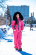 © Andrey_Arkusha - portrait of a young woman in a pink winter outfit with a fur hood