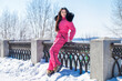 © Andrey_Arkusha - portrait of a young woman in a pink winter outfit with a fur hood