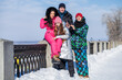 © Andrey_Arkusha - Young family of four walking outdoors in winter