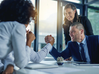 theyre at loggerheads. shot of two businesspeople arm wrestling during a meeting in the boardroom.