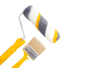 Wall Mural - Paint roller and brush for wall painting and repair, on white background.