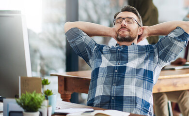 Poster - Hes always dreaming of success. Cropped shot of a mature businessman taking a break at his desk.