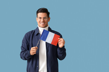 Canvas Print - Handsome young man with flag of France on blue background