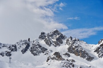 Wall Mural - Peak of a snowcapped mountain in winter 