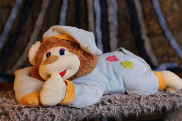  Sleepy teddy bear wearing classic pajamas