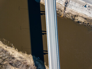 Wall Mural - Aerial view of new bridge over Venta river in sunny spring day, Kuldiga, Latvia.