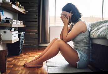 Canvas Print - I just cant get over him. Full length shot of an attractive young woman looking depressed while sitting on the floor in her bedroom at home.