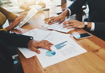 Aufkleber - Lets see what the numbers say. Closeup shot of an unrecognizable group of businesspeople going through paperwork in an office.