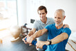 © Lyndon S/peopleimages.com - Just a few seconds more. Shot of a young male physiotherapist helping a client with stretching exercises in his office during the day.