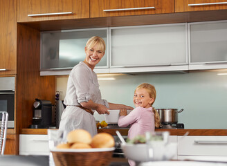 Sticker - Fun times with mom in the kitchen. Portrait of an attractive young woman in the kitchen with her adorable daughter.