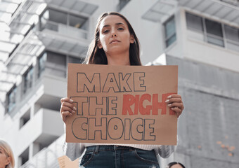 make the right choice for you. cropped portrait of an attractive young woman holding up a sign prote