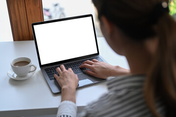 Wall Mural - Over shoulder business woman checking email on laptop computer.