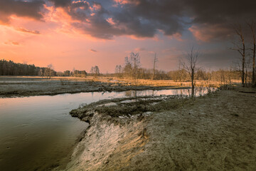 Colorful sunset over a small river.