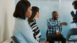 © DC Studio - African american woman waiting to receive cv and attend job interview with HR department. Female applicant sitting in office lobby, getting ready for meeting appointment about employment.