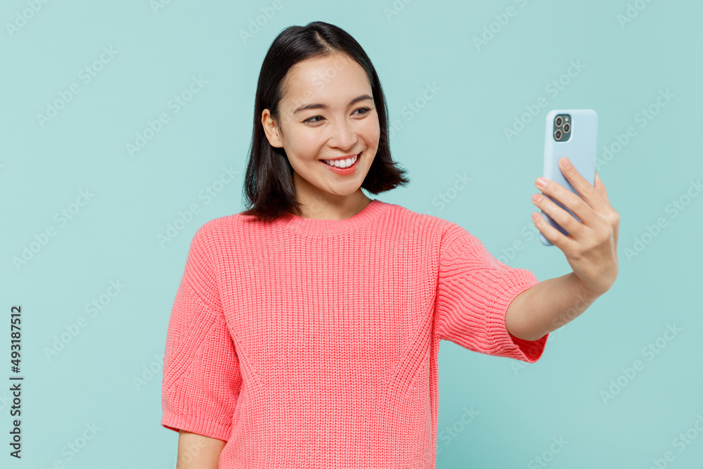 Young smiling happy woman of Asian ethnicity 20s wearing pink sweater ...