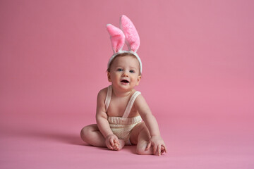 portrait of sitting little baby wearing bunny costume