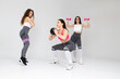 Three fitness girls exercising in the studio