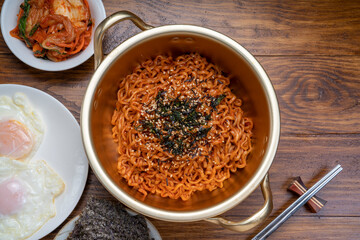 Korean traditional Ramyeon noodle in a traditional korean noodle pot, Spicy Korean Ramyeon instant noodle a traditional dish.